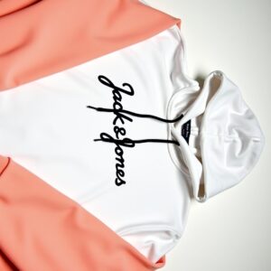 White fleece hoodie with black “Jack & Jones” logo and black drawstrings on display.